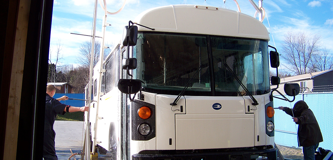 photo of bus with water being sprayed on it