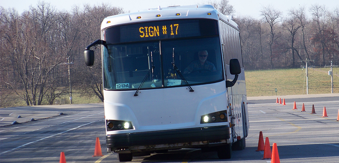 bus driving through orange cones during a lane change test